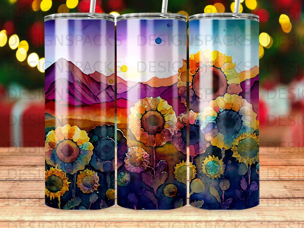 Three tumblers with sunflower and mountain landscape design.