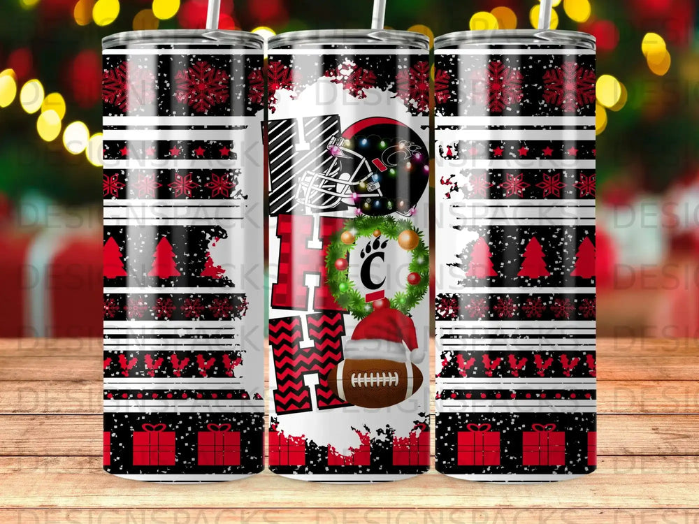 Tumbler with "HO HO HO" and football, snowflakes, and gifts design.