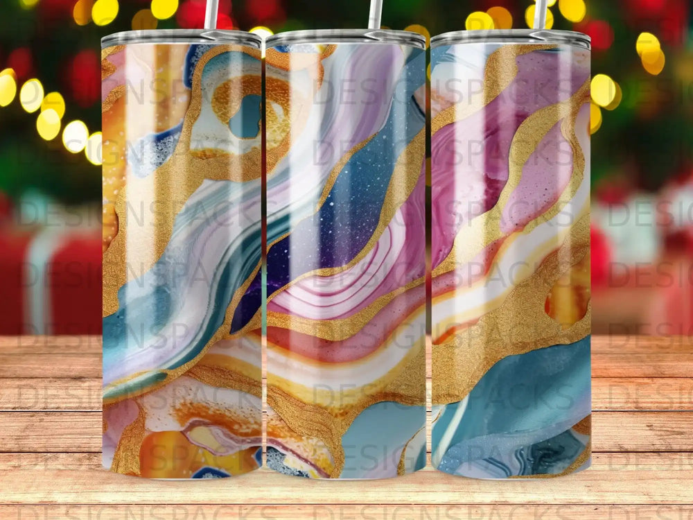 Three tumblers with marbled blue, pink, and gold abstract design.