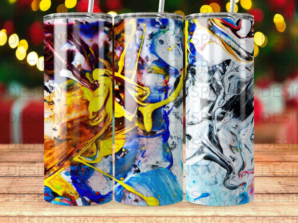 Three tumblers with abstract paint splatter designs in blue, yellow, and red.