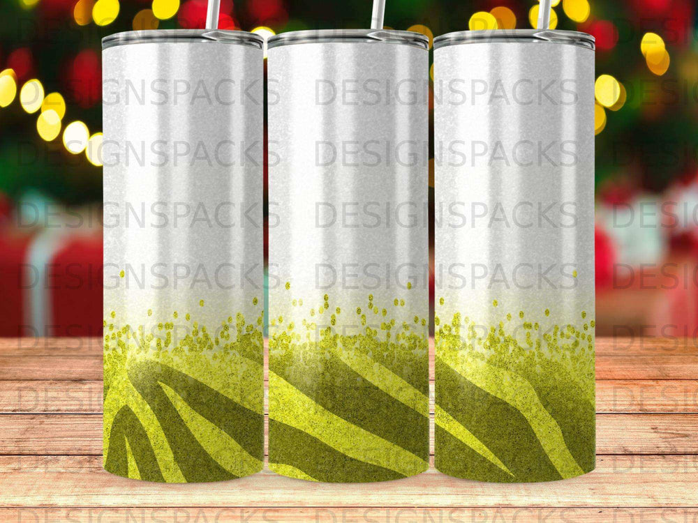 White tumbler with zebra pattern and glitter accents on wooden surface.