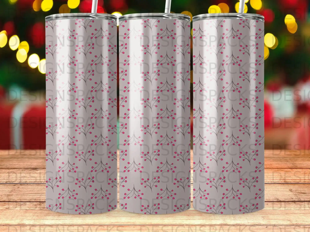 Three tumblers with a pink berry and branch pattern on a wooden surface.