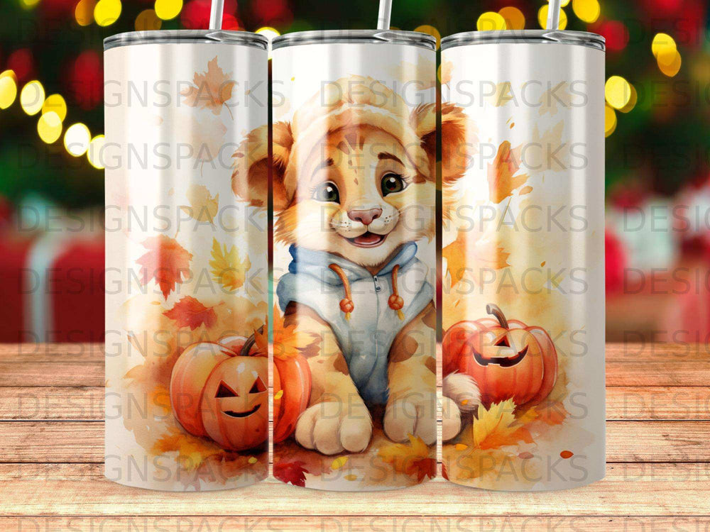 Lion cub and pumpkins on tumbler, fall leaves, blurry lights background.