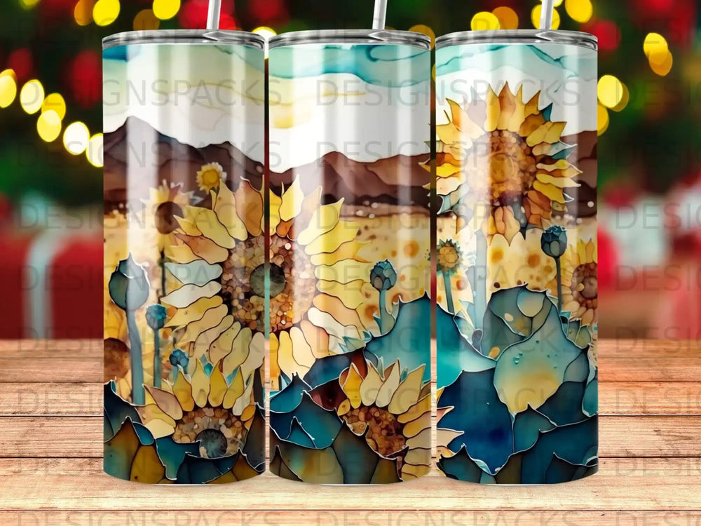Three tumblers with a watercolor sunflower and mountain landscape design.