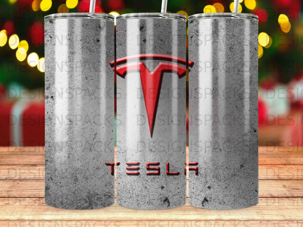 Silver tumbler with Tesla logo and name on a concrete background.